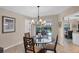 Dining area featuring a glass table, chandelier, and views of the outdoor pool and patio at 316 Signorelli Dr, Nokomis, FL 34275
