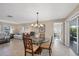 Open floor plan with dining area, tile floors, and access to the outdoor patio area at 316 Signorelli Dr, Nokomis, FL 34275