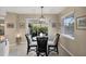 Dining area features a round glass table and decorative lighting, with a view to the patio at 316 Signorelli Dr, Nokomis, FL 34275