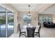 Dining area with glass table and wicker chairs, adjacent to the outdoor pool area at 316 Signorelli Dr, Nokomis, FL 34275