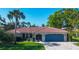 Charming single-story home with a well-manicured lawn, blue garage door, and a brick driveway at 316 Signorelli Dr, Nokomis, FL 34275