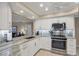 Modern kitchen with white cabinets, stainless steel appliances, and granite countertops at 316 Signorelli Dr, Nokomis, FL 34275