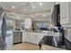 Modern kitchen featuring granite countertops, stainless steel appliances, and an open layout at 316 Signorelli Dr, Nokomis, FL 34275