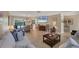 Spacious living room featuring tile floors, a dining area, comfortable seating, and backyard views at 316 Signorelli Dr, Nokomis, FL 34275