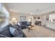 Comfortable living area with a large sectional sofa, tile flooring, and a view to the kitchen at 316 Signorelli Dr, Nokomis, FL 34275