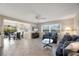 Open-concept living room with dining area, tile floors, and access to the outdoor patio at 316 Signorelli Dr, Nokomis, FL 34275