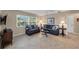 Cozy living room featuring tile floors, comfortable seating, and natural light from the window at 316 Signorelli Dr, Nokomis, FL 34275