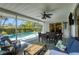 Enclosed patio area with furniture, ceiling fan and view of a swimming pool at 316 Signorelli Dr, Nokomis, FL 34275