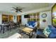 Enclosed patio with furniture, ceiling fan and sliding doors overlooking the yard at 316 Signorelli Dr, Nokomis, FL 34275