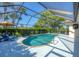 Screened in swimming pool with outdoor furniture and landscaping in the background at 316 Signorelli Dr, Nokomis, FL 34275