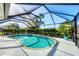 Screened-in pool area features a kidney-shaped pool, lounge chairs, and well-maintained greenery for outdoor relaxation at 316 Signorelli Dr, Nokomis, FL 34275