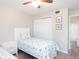 Bright bedroom featuring a twin bed, closet, and doorway to the on-suite bathroom at 3255 Beneva Rd # 102, Sarasota, FL 34232