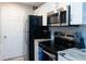Contemporary kitchen with stainless steel appliances, granite countertops, and white cabinetry at 3255 Beneva Rd # 102, Sarasota, FL 34232