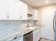 Updated kitchen with white cabinets, granite countertops, and stainless steel appliances at 3255 Beneva Rd # 102, Sarasota, FL 34232