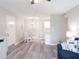 Open-concept living area with dining table, gray flooring, and neutral color scheme at 3255 Beneva Rd # 102, Sarasota, FL 34232