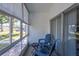 Relaxing screened patio featuring bright blue outdoor chairs and a view of the surrounding yard at 3255 Beneva Rd # 102, Sarasota, FL 34232