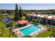 Refreshing community pool surrounded by palm trees and plenty of lounge chairs at 3255 Beneva Rd # 102, Sarasota, FL 34232