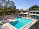 Inviting community pool with poolside seating and views of the surrounding buildings at 3255 Beneva Rd # 102, Sarasota, FL 34232