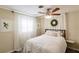 A charming bedroom with sheer curtains, leafy artwork, and a cozy bed at 3716 Mundy Ridge Dr, Sarasota, FL 34233