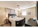 A well-lit main bedroom features a double bed, bedside tables, and tasteful decor at 3716 Mundy Ridge Dr, Sarasota, FL 34233