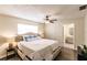A serene main bedroom features a tufted headboard and a view to a modern ensuite bath at 3716 Mundy Ridge Dr, Sarasota, FL 34233