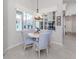 Breakfast nook with pool views, chandelier lighting, and a modern window design at 396 Lansbrook Dr, Venice, FL 34292