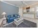 Living room with light blue accent wall and mini bar and sink area for entertaining at 396 Lansbrook Dr, Venice, FL 34292