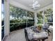 Relaxing screened-in patio with comfortable seating and views of the beautifully landscaped backyard at 396 Lansbrook Dr, Venice, FL 34292