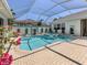 Screened pool area with a pool, spa, and plenty of space for outdoor entertaining at 396 Lansbrook Dr, Venice, FL 34292