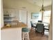 Bright dining area features a table with seating for four and views of the backyard at 4244 Vicenza Dr # D34, Venice, FL 34293
