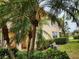 Beautiful condo with mature palm trees, manicured landscaping, and well-maintained facade at 4244 Vicenza Dr # D34, Venice, FL 34293