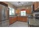 Updated kitchen with stainless steel appliances, granite countertops, and natural lighting at 4244 Vicenza Dr # D34, Venice, FL 34293