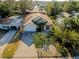 Expansive aerial view of a charming single-Gathering home with lush greenery, a driveway, and a well-kept yard at 429 Riviera St, Venice, FL 34285