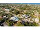 Expansive aerial view of the neighborhood, showing the home's location and surrounding greenery with ocean backdrop at 429 Riviera St, Venice, FL 34285