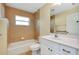 Well-lit bathroom with a shower-tub combo, white vanity, and neutral tile at 429 Riviera St, Venice, FL 34285
