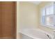 Bathroom featuring walk-in shower, plantation shutters, and soaking tub at 429 Riviera St, Venice, FL 34285