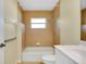 Tiled bathroom with tub-shower combo, white vanity, and accessible features at 429 Riviera St, Venice, FL 34285