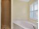 Bathroom featuring walk-in shower, plantation shutters, and soaking tub at 429 Riviera St, Venice, FL 34285
