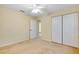 Neutral bedroom with carpet, ceiling fan, and double door closet at 429 Riviera St, Venice, FL 34285