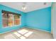 Bright blue bedroom features a ceiling fan and window with blinds at 429 Riviera St, Venice, FL 34285