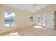 This bedroom offers carpeted floors, neutral walls and access to the backyard pool at 429 Riviera St, Venice, FL 34285