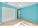 Bright blue bedroom features a ceiling fan and closet space at 429 Riviera St, Venice, FL 34285