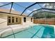 Beautiful home exterior featuring a screened-in pool, patio, and well-maintained backyard at 429 Riviera St, Venice, FL 34285