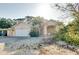 Charming single-story home with a two-car garage, a palm tree, and mature landscaping for added curb appeal at 429 Riviera St, Venice, FL 34285