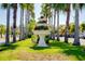 Ornate tiered fountain with colorful flowers amidst palm trees lining the street at 429 Riviera St, Venice, FL 34285