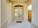 Elegant double front doors with glass panes, complemented by a decorative transom window and neutral paint at 429 Riviera St, Venice, FL 34285