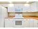 A close-up showcasing the kitchen's white oven and stovetop at 429 Riviera St, Venice, FL 34285