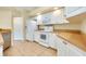 Well-lit kitchen with white appliances, ample counter space, and tiled flooring at 429 Riviera St, Venice, FL 34285