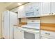 Close-up of white stove, microwave, and refrigerator in kitchen at 429 Riviera St, Venice, FL 34285