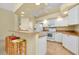 Bright kitchen with white cabinets and breakfast bar at 429 Riviera St, Venice, FL 34285